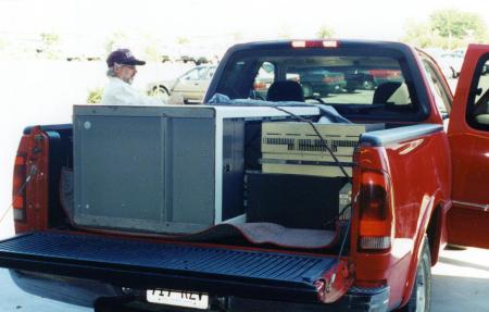 [The transmitter is loaded into a truck]